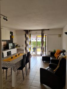 a living room with a couch and a table and chairs at Vacances relax à Bredene in Bredene