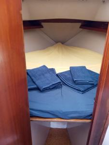 a bunk bed with blue towels on top of it at Lisbon Cosy Boat in Lisbon
