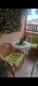 a patio with a table and chairs and a table with a plant at Apartments Luna Kumanovo in Kumanovo