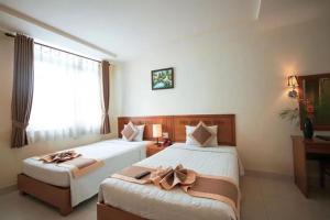 Postel nebo postele na pokoji v ubytování Bunny - Valentine Hotel - Bui Vien Street