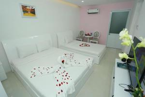 Postel nebo postele na pokoji v ubytování Bunny - Valentine Hotel - Bui Vien Street