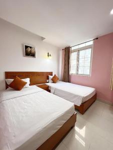 Postel nebo postele na pokoji v ubytování Bunny - Valentine Hotel - Bui Vien Street