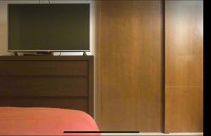 a bedroom with a television on a dresser at comfortable and cool suite in Polanco with GYM in Mexico City