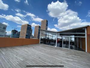 a rooftop of a building with a view of the city at comfortable and cool suite in Polanco with GYM in Mexico City