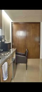a kitchen with a leather chair in a room at comfortable and cool suite in Polanco with GYM in Mexico City