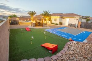 a miniature golf course in a backyard with a house at 3400 SqFt House W/40Ft Heated Pool/Spa- Strip View in Las Vegas