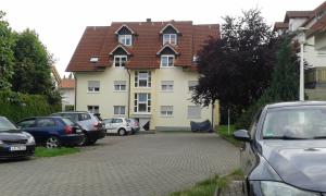 a large house with cars parked in front of it at FeWo Zakharov in Lahr