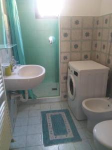 a bathroom with a sink and a toilet and a shower at Appartamento 4 - NEW in Comezzano