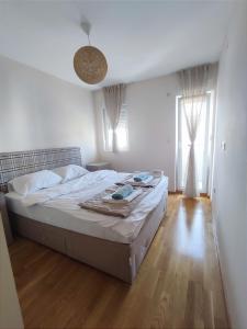 a bedroom with a large bed in a room at CITY POINT Apartment in Podgorica