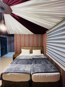 a bedroom with a large bed in a room at Madar Camp, Wadi Rum in Wadi Rum