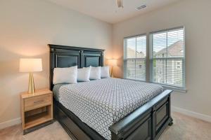 a bedroom with a bed with a lamp and a window at Barefoot Resort & Golf. Near Barefoot Landing. in North Myrtle Beach