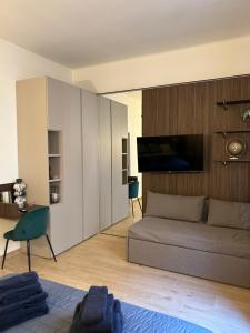 a living room with a couch and a tv at ALBARI HOUSE in Bologna