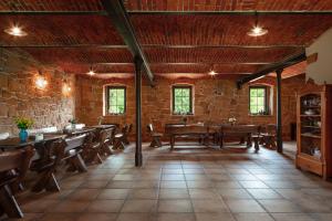 a large room with tables and chairs and a brick wall at Agrohippika in Kondratów