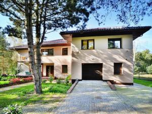 a house with a driveway in front of it at Semi-detached house, Mielno in Mielno