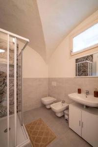 a bathroom with a sink and a toilet and a shower at Lavinia Suite - Romantic & New! in Marone