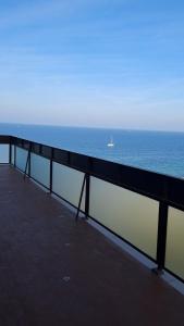 a pier with a boat in the ocean at Attico Suite spiaggia Bari in Bari