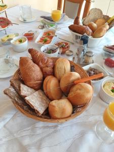 a table topped with a plate of bread and pastries at B & B Buchhorst 21481 in Buchhorst