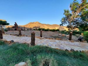 a stone path in the middle of a field with mountains in the background at Oasis Panorama Hotel in Bawati