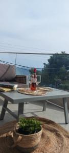 a table on a balcony with a view of the ocean at Wide Blue Luxury Boutique Suites in Neos Marmaras