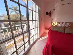 a bedroom with a bed and a large window at Los Preferidos in Colón