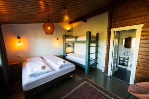 a bedroom with two beds and a bunk bed at Hótel Goðafoss Fosshóll in Godafoss