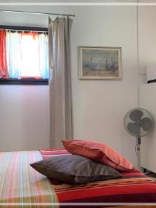 Postel nebo postele na pokoji v ubytování Le CaRaMeLle di Baratti