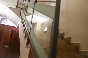 a staircase in a house with a glass railing at Dimora Notar Domenico -GRAVINA IN PUGLIA- in Gravina in Puglia