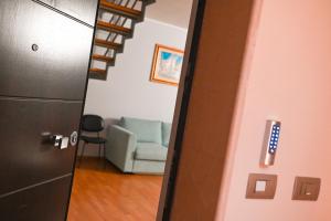 a hallway with a stairway with a couch in a room at Dimora Notar Domenico -GRAVINA IN PUGLIA- in Gravina in Puglia