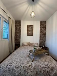 een slaapkamer met een groot bed en een tafel bij Apartment Su Casa 
