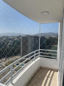 a white balcony with a view of the city at Departamento nuevo en reñaca alto 2 dormitorios in Viña del Mar