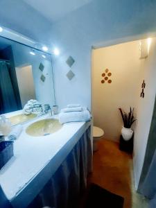 a bathroom with a sink and a large mirror at STUDIO LOFT MEDINA AVEC TERRASSE in Marrakech