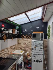 een keuken met een fornuis en een raam erin bij Kitnet Apartamento Praia Matinhos in Matinhos