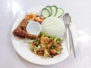 a plate of food with rice and meat and vegetables at Isla Haruhay in Dapa