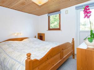 1 dormitorio con cama de madera y ventana en Holiday home Aabenraa LXXVI, en Aabenraa