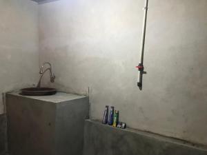 a bathroom with a sink and a sink at Muni's Lombok Bungalow in Masbagik