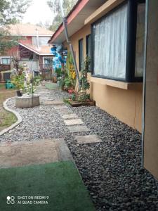 a house with a gravel walkway next to a house at Hostal¤ Familiar¤ in Chillán