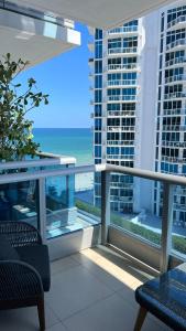 a balcony with a view of the ocean at Monte Carlo Suites in Miami Beach in Miami Beach