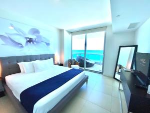 a bedroom with a bed and a view of the ocean at Monte Carlo Suites in Miami Beach in Miami Beach