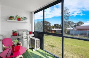 a kitchen with a large window and a green yard at A Larger Slice of Fremantle 3bed apt. Wifi-Netflix in Fremantle