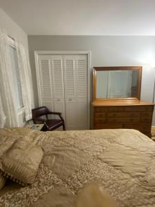 a bedroom with a bed and a dresser and a mirror at Caribbean Comfort Zone in Chesterfield