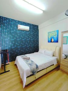 ein Schlafzimmer mit einem Bett und einer blauen Wand in der Unterkunft D'luna homestay Terengganu No.3 Pusat Bandar / Seaview / City View/ Drawbrige View in Kuala Terengganu