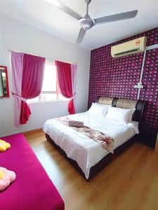 ein Schlafzimmer mit einem großen Bett mit einer rosa Wand in der Unterkunft D'luna homestay Terengganu No.3 Pusat Bandar / Seaview / City View/ Drawbrige View in Kuala Terengganu
