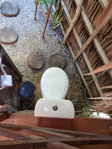 a bathroom with a toilet in the ground at Ecocamping Lumiar in Amontada