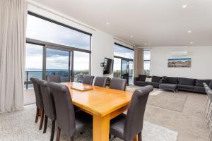 a dining room with a table and chairs at Pembroke Heights in Moeraki