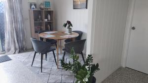a dining room table and chairs in a room at Hidden Gem Holiday Let in South Mission Beach