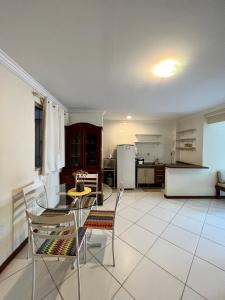 a kitchen and dining room with a table and chairs at Residencial Ribeiro in Salvador