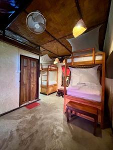 a bedroom with two bunk beds in a room at Sa Sa Lao in Luang Prabang