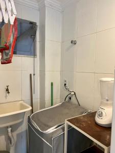 a small bathroom with a sink and a toilet at Residencial Ribeiro in Salvador