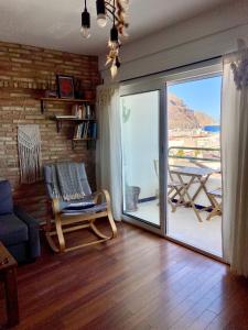 ein Wohnzimmer mit einer Glasschiebetür zu einem Balkon in der Unterkunft Bonito apartamento con vistas al mar in Las Negras
