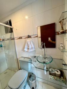 a bathroom with a toilet and a sink at Residencial Ribeiro in Salvador